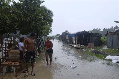Dominican officials inspect damage inflicted by Tropical Storm Franklin after heavy flooding